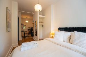 a bedroom with a large white bed with white pillows at Lamartine Chelsea in New York