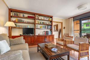 a living room with a couch and a tv at Chalet Picu Fontanielles en Colunga in Colunga