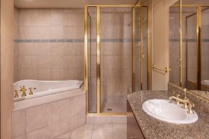 a bathroom with a tub and a sink and a shower at Circus Circus Reno, A Caesars Destination in Reno +57 photos