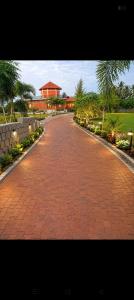 a red brick road with a building in the background at JayKay Resort in Pūrnānkuppam