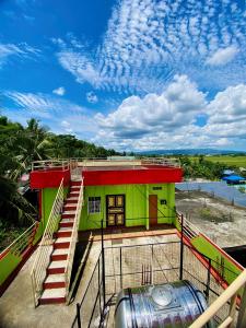 a building with a green and red building at Polangui Transient Room A Simple Transient House in Polangui