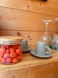a wooden shelf with a jar of fruit and a teaucer at La Petite Maison d'Emma in Vidauban