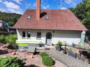 a small white house with a red roof at Janas Pfälzerwaldglück in Lemberg