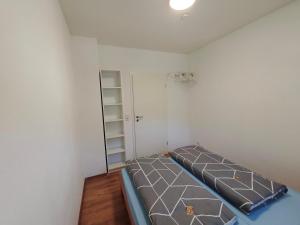 a small room with a bed and a closet at Janas Pfälzerwaldglück in Lemberg