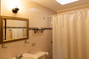 a bathroom with a shower curtain and a sink at Hostal Villa Toscana in Guatemala +76 photos