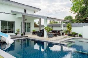 a house with a swimming pool and a patio at Blue Lake Residences - Pattaya in Nong Prue