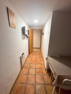 a corridor of a room with a table and a hallway at Ca la Selma in Aiguamurcia
