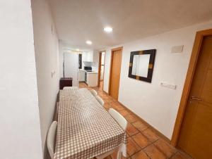a room with a table and chairs and a hallway at Ca la Selma in Aiguamurcia