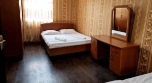 a bedroom with a bed and a dresser and a mirror at Debi in Lentekhi