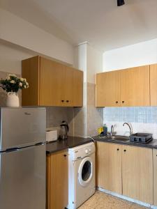 a kitchen with a refrigerator and a washing machine at Galtheo in Lachi +24 photos