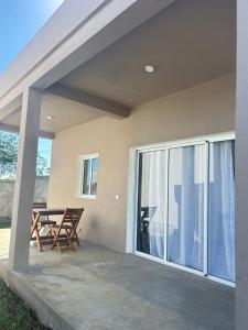 a patio with a table and chairs and a sliding glass door at Villa Soa in Nosy Be
