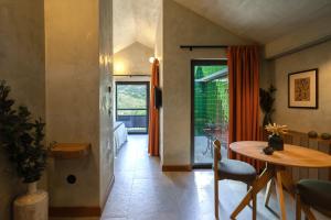 a room with a table and a dining room with a window at Passinhos House in Amarante