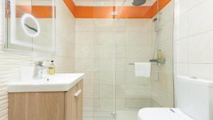 a bathroom with a shower and a sink and a toilet at Cliff Refuge by LovelyStay in Santa Cruz +20 photos