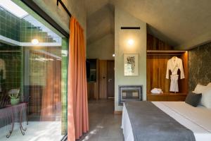 a bedroom with a bed and a fireplace at Passinhos House in Amarante +163 photos
