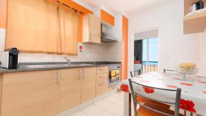 a kitchen with a table and a dining room at Cliff Refuge by LovelyStay in Santa Cruz