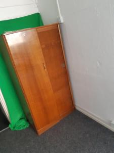 a wooden cabinet in a corner of a room at VOB Enterprises in Chatham