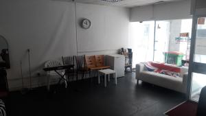 a living room with a couch and a clock on the wall at VOB Enterprises in Chatham
