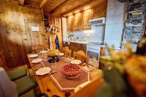 a kitchen with a table and chairs in a room at Chalet Louchelet in Hérémence