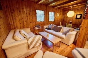 a living room with two couches and a table at Chalet Louchelet in Hérémence