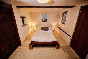 a bedroom with a bed and two lamps in it at Chalet Louchelet in Hérémence