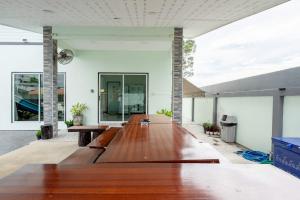 an open living room with a long wooden table at Blue Lake Residences - Pattaya in Nong Prue +92 photos