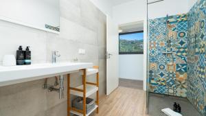 a bathroom with a sink and a shower at Villa Calhau by LovelyStay in Ponta do Sol +57 photos