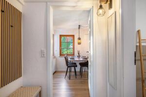a hallway leading to a dining room with a table at Ferienhaus Schmuckstück in Schiltach +20 photos