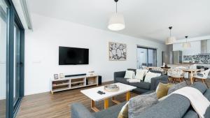 a living room with a couch and a table at Villa Calhau by LovelyStay in Ponta do Sol