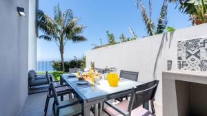 a blue table and chairs on a patio at Villa Calhau by LovelyStay in Ponta do Sol