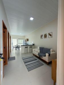 a living room with a couch and a table at Casa 02 - Aconchegante e cheia de estilo - 5 min do centro in Alta Floresta
