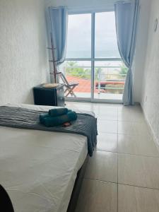 a bedroom with a bed with a view of the ocean at Surf Zone Hostel in Saquarema