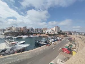 a group of boats docked at a marina at La pineda in Les tres Cales
