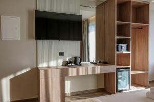 a kitchen with a counter with a sink and a microwave at Hotel Olserd in Ksamil