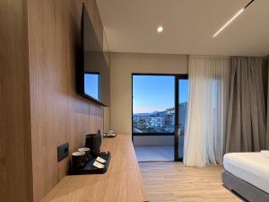 a bedroom with a bed and a window with a view at Hotel Olserd in Ksamil