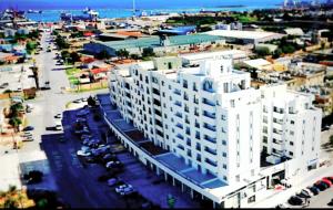 an aerial view of a large white apartment building at Port View Hotel in Famagusta