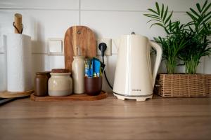 a kitchen counter with a coffee maker and a toaster at Historic Karaimai Street Balcony Apartment, Trakai, Lithuania in Trakai
