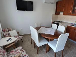 a kitchen and dining room with a table and chairs at Apartment Kristijan in Pag