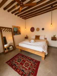 a bedroom with a large bed and a red rug at Mayssa Villa in Paje +16 photos