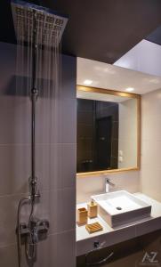 a bathroom with a sink and a mirror at Phaedra Apartment in Athens