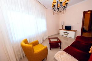 a living room with a couch and a chair at Casa Maruja O Grove in O Grove