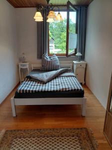 a bed sitting in a room with a window at Rurterasse in Monschau
