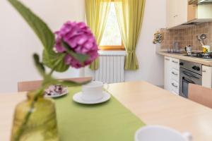 a vase with a flower on a table in a kitchen at Residence Da Carmelo in Palinuro +45 photos