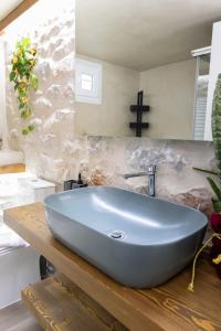 a bathroom with a blue sink on a wooden counter at Mani Spot Casa Elia in Areopoli +48 photos