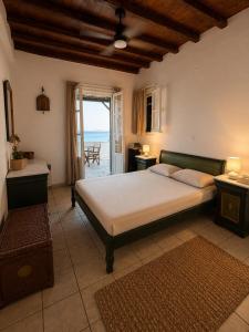 a bedroom with a bed and a view of the ocean at Above the Blue in Agios Sostis