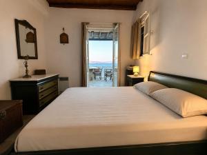 a bedroom with a bed and a view of the ocean at Above the Blue in Agios Sostis