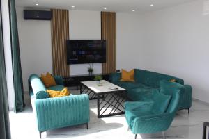 a living room with a couch and two chairs and a table at Villa New York in Novalja