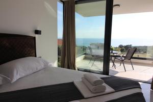 a bedroom with a bed and a view of a patio at Villa New York in Novalja +43 photos