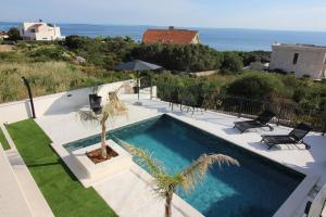 a swimming pool with a view of the ocean at Villa New York in Novalja