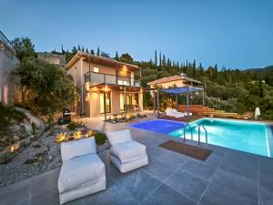 a home with a swimming pool and a house at euphoria villas - Gaia & Aura in Agios Nikitas