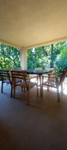 two picnic tables in a room with trees in the background at Casa 33 in Gardone Riviera